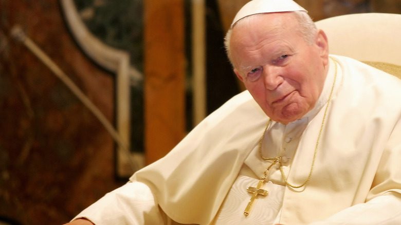 Папа Иоанн Павел II улыбается во время встречи с кем-то