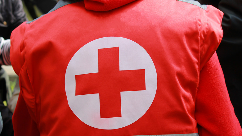 Работник Красного Креста со знаками отличия на куртке